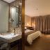 James Joyce Coffetel San Yuan LI Station, Guangzhou guest room with bed, desk and vanity mirror