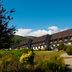 Isle Of Mull Hotel and Spa on the Isle of Mull with hillside setting, garden, and clear blue sky