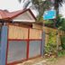 El Taraw Bed And Breakfast in Puerto Princesa, roadside entrance with gate and tropical palms