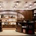 Emeline Charleston hotel lobby with wood shelving, arched display wall and warm ceiling lights
