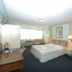 Lopburi Inn Hotel in Lop Buri: guest room with bed, desk, window seating and an open bathroom doorway