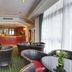Borgo Palace Hotel in Sansepolcro lobby lounge with wicker chairs, round tables and a wood bar
