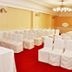 Austral Bahia Blanca Hotel meeting room with rows of white-covered chairs and a red carpet in Bahía Blanca