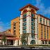 Home2 Suites by Hilton Orlando at FLAMINGO CROSSINGS Town Center in Bay Lake exterior with palm trees