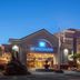 Wyndham Visalia exterior at dusk with lit entrance and fountain