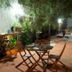 Colibri Hotel B&B in Tepoztlán: shaded garden patio with wooden table, chairs and lounge seating