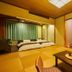 Ooedo Onsen Monogatari Kaike in Yonago: tatami room with futons, low table, and TV