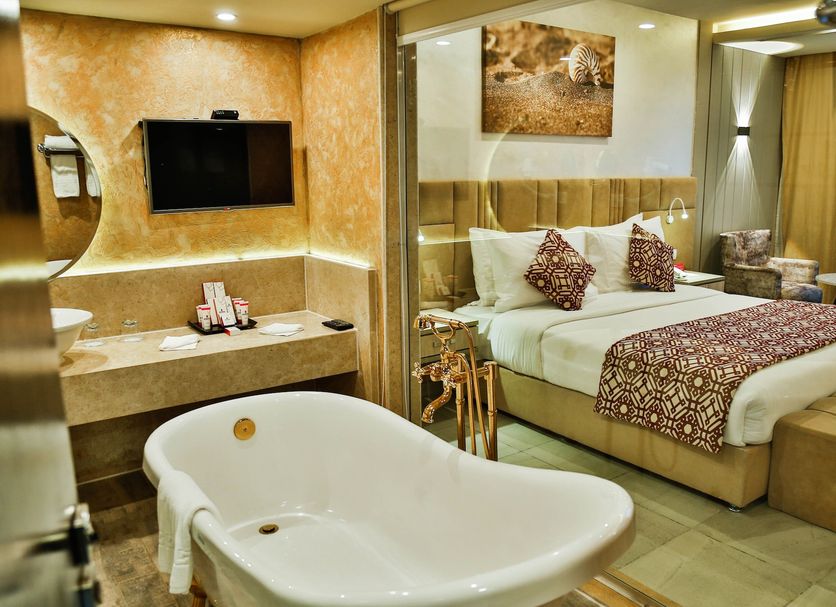 Amarina Abu Soma Resort & Aquapark in Safaga with bedroom, bathtub and glass-partitioned bathroom