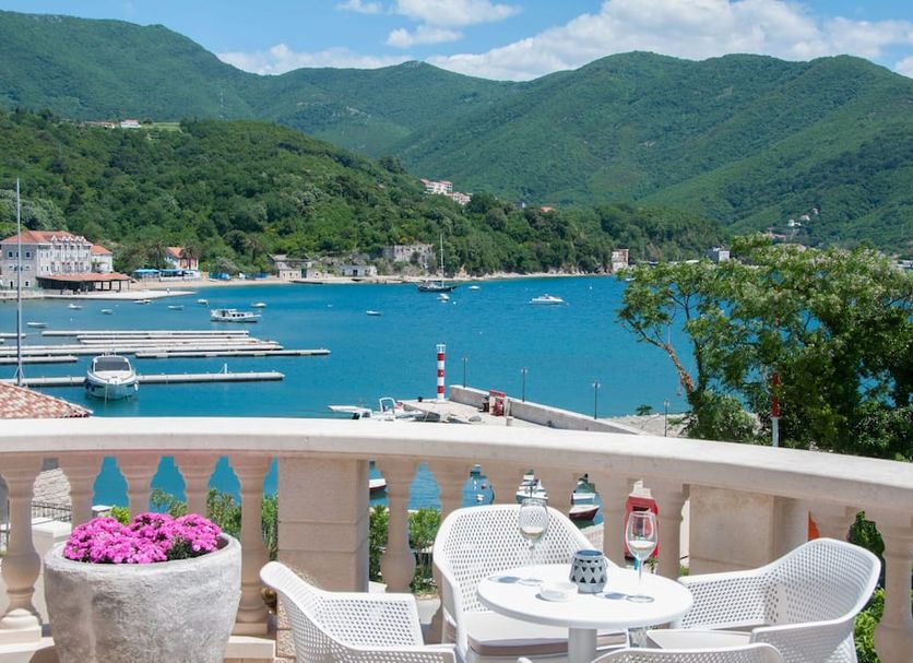 Boutique Hotel Kredo in Herceg Novi balcony with table, chairs and bay and mountain view