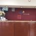 Express Inn West Memphis reception desk and lobby counter with maroon wall and check-in area