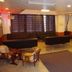 Hakuba Gondola Hotel in Hakuba lobby with black sofas, chairs, and coffee tables