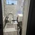 Bathroom at The Royal Princess Garden in Randburg with toilet, sink, and marble-look wall tiles