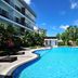BS Residence Suvarnabhumi in Bangkok with a large outdoor swimming pool between modern buildings