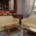 Evans Hotel Heraklion lounge with beige sofas, wooden tables and a bar area