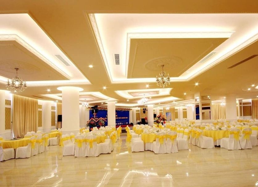 Nha Trang Palace Hotel in Nha Trang ballroom setup with yellow chair covers and chandeliers