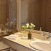 Los Ponchos Hotel in El Calafate bathroom with bathtub, sink, mirror, and neatly arranged toiletries.