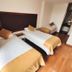 Hotel Dorado Ferial Bogotá guest room with two single beds and wood flooring