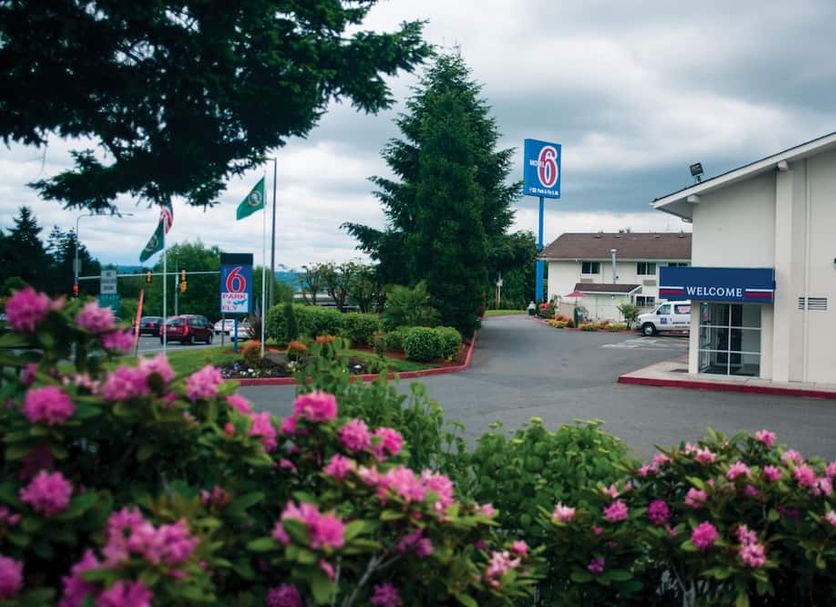 Motel 6-Seattle, Wa - Sea-Tac Airport South exterior with parking lot and landscaped flowers in SeaTac