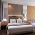 Neotel Hotel City Centre in Tanjung Redeb, modern guest room with king bed and chaise lounge