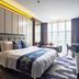 Wuxi Idea Garden Hotel in Wuxi, modern guest room with large bed, sofa, desk, and floor-to-ceiling window