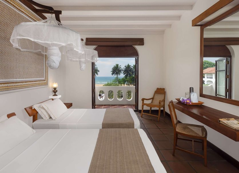 Heritance Ayurveda in Beruwala bedroom with twin beds and ocean view through open balcony