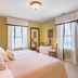 Brick Street Inn guest room in Zionsville with king bed, tall windows, and antique armoire