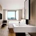 Fairfield by Marriott Busan guest room with twin beds, vanity, TV and city view in Busan