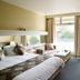 Comfort Inn & Suites Lakes Entrance guest room with twin beds, balcony door, and natural light