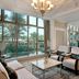 Waldorf Astoria Ras Al Khaimah lounge with palm views through large windows and chandeliers