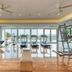 The Ubufuru Ishigaki gym with treadmills, weights and ocean-view windows in Ishigaki