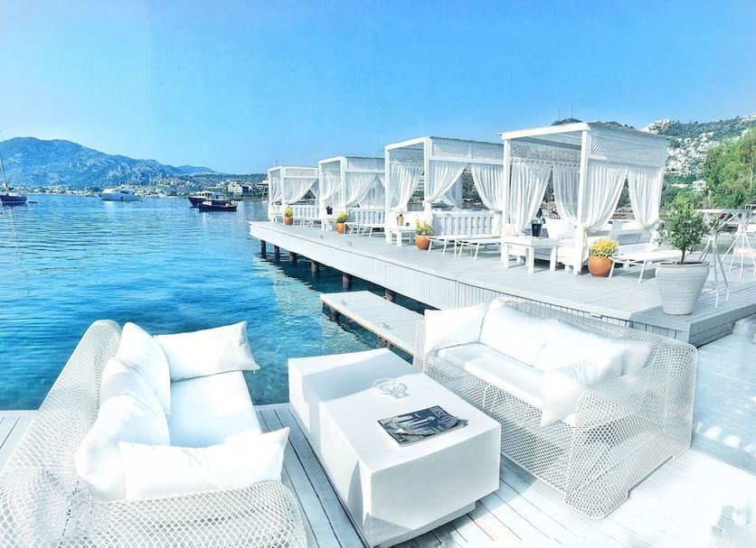 Bilkent Casa Costa Hotel in Gündoğan, waterfront cabanas and white loungers overlooking the sea