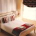 The Globe Inn Tiverton bedroom with double bed, bedside lamps, and window light