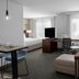 Residence Inn by Marriott Santa Clarita Valencia suite with desk, sofa, TV and large windows