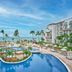 Fiesta Americana Cancun Villas in Cancún with ocean-view pool, palm trees, and beachfront loungers