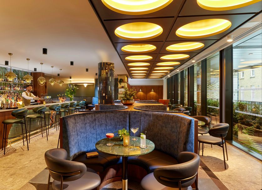 The Chancery Hotel Dublin bar and lounge with curved booth seating, glowing ceiling lights, and floor-to-ceiling windows