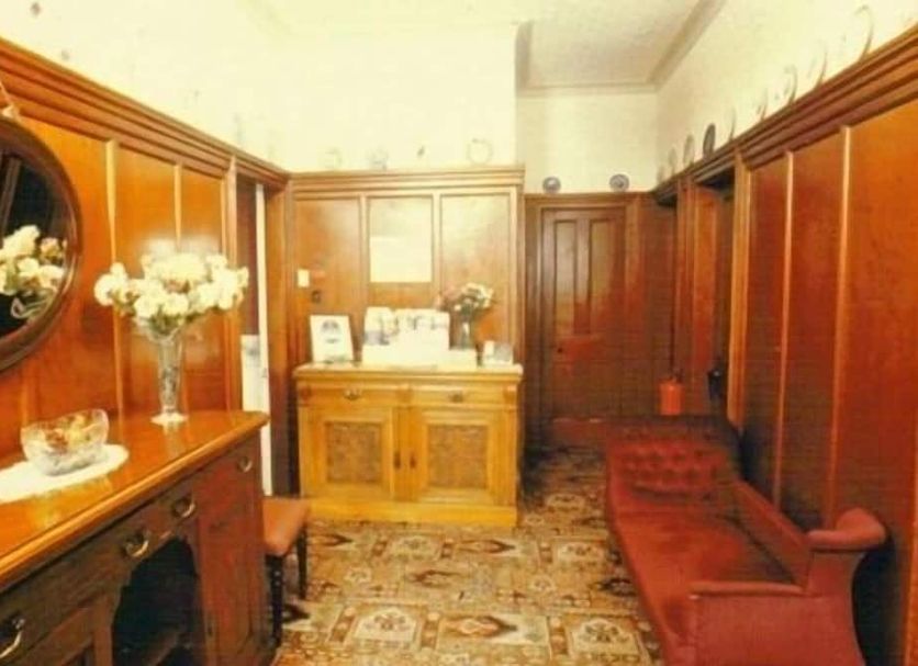 Murrayfield Park Guest House in Edinburgh lobby with wood paneling, cabinet, and patterned carpet