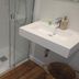 Hotel San Nikolas Sea Views bathroom with glass shower, wall-mounted sink and toilet in Hondarribia