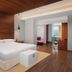 Aloft Bengaluru Outer Ring Road guest room with king bed, wood accents, and city-view window