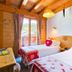 Chalet Hotel Aiguille Blanche Logis in Les Gets guest room with two twin beds and wood-paneled ceiling