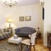 El Rincón de Gran Vía in Madrid, sitting room with striped sofa, loveseat, coffee table and lamp