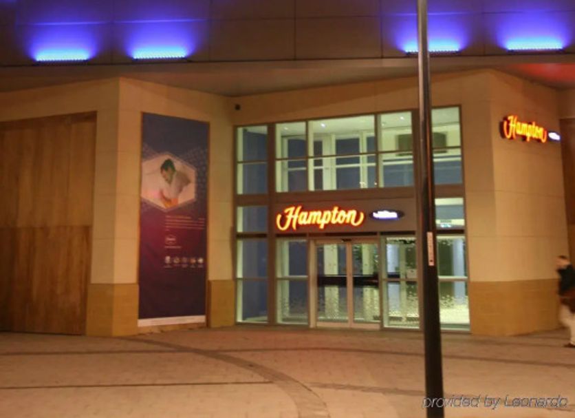 Hampton By Hilton Derby City Centre exterior at night in Derby, with illuminated entrance and blue accent lighting