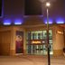 Hampton By Hilton Derby City Centre exterior at night in Derby, with illuminated entrance and blue accent lighting