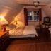 Gîte Au Coin De La Berge bedroom in Percé with clawfoot bathtub and sloped ceiling