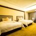 Changchun Huatian Hotel in Changchun guest room with two twin beds and seating area