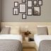 The Pergola Design Hotel in Da Nang guest room with two twin beds and framed wall art