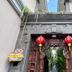 De' Bharata Bali Villas Kuta entrance with stone gateway, red lanterns, and hanging greenery