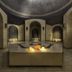 Adalya Art Side in Side: ornate indoor spa lounge with arched alcoves and a central candlelit feature