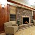 Holiday Inn Express & Suites Lewisburg lobby with stone fireplace and seating area