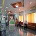 Sai Sangam Hotel in Shirdi lobby with reception desk, seating areas, and polished floor