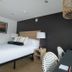 The Waypoint in Rehoboth Beach room with bed, bedside lamp, desk, and large window